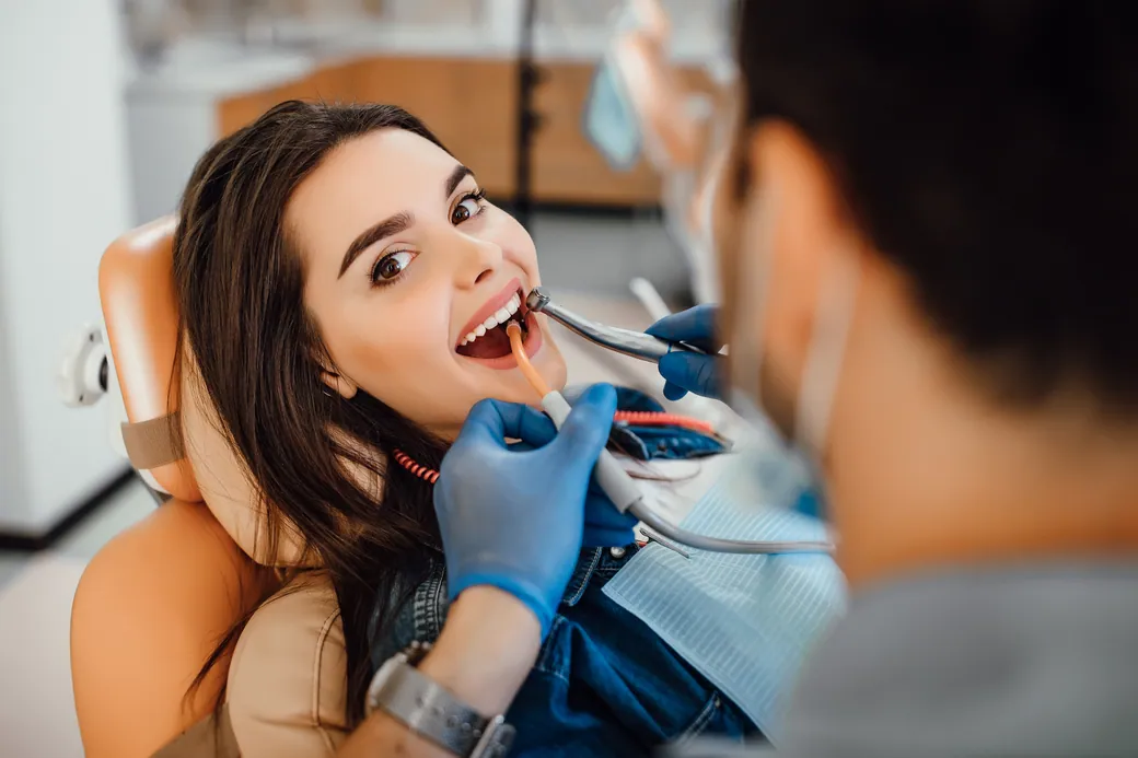 Dentist examining a smiling patient's teeth