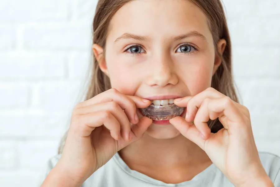 Orthodontist checking a child's bite