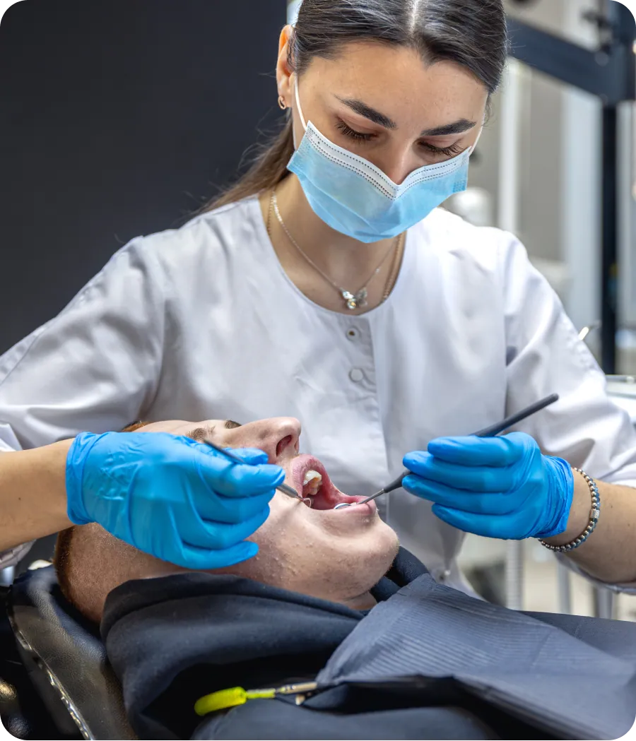 Dentist performing root canal treatment