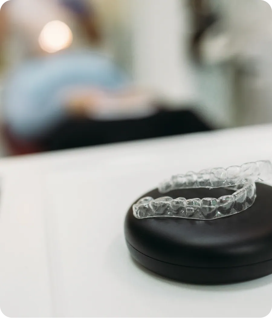 Clear aligner held by a patient